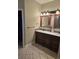 Bathroom featuring double vanity sinks with decorative mirrors and lighting with tile flooring at 1717 Perdiz Covey Ct., Myrtle Beach, SC 29588