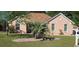 Charming brick home with a well-manicured lawn, a palm tree, and mature trees providing shade at 1717 Perdiz Covey Ct., Myrtle Beach, SC 29588