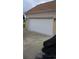 Attached two-car garage featuring a white door and brick exterior at 1717 Perdiz Covey Ct., Myrtle Beach, SC 29588