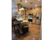 Modern kitchen featuring stainless steel appliances, wooden cabinets, hardwood floors, and counter seating at 1717 Perdiz Covey Ct., Myrtle Beach, SC 29588