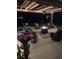 Inviting outdoor patio area with stylish seating, a cozy fire pit, and decorative string lights at 1717 Perdiz Covey Ct., Myrtle Beach, SC 29588