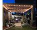 Inviting outdoor patio with string lights, a fire pit, and comfortable seating, perfect for evening gatherings at 1717 Perdiz Covey Ct., Myrtle Beach, SC 29588