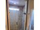 Bathroom shower featuring a pebble tile wall design and glass door enclosure at 1717 Perdiz Covey Ct., Myrtle Beach, SC 29588