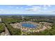 Aerial of neighborhood surrounding a lake with fountain and ocean view beyond the trees at 179 Hyacinth Loop, Murrells Inlet, SC 29576