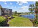 Beautifully landscaped backyard with a screened porch and a tranquil lake view at 179 Hyacinth Loop, Murrells Inlet, SC 29576