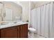 Bathroom with vanity, sink, toilet, and shower with patterned curtain at 179 Hyacinth Loop, Murrells Inlet, SC 29576
