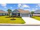 Charming home with manicured lawn, palm trees, and an American flag waving in the breeze at 179 Hyacinth Loop, Murrells Inlet, SC 29576