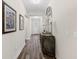 Elegant hallway with hardwood floors, decorative mirror, and stylish decor at 179 Hyacinth Loop, Murrells Inlet, SC 29576
