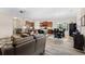 Open-concept living room with hardwood floors, dining area, and a view of the kitchen at 179 Hyacinth Loop, Murrells Inlet, SC 29576