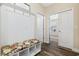 Inviting mudroom with a floral bench, hooks, storage cubbies, and wood look flooring at 179 Hyacinth Loop, Murrells Inlet, SC 29576