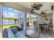 Inviting screened-in patio featuring outdoor seating, ceiling fans, and lovely lake views at 179 Hyacinth Loop, Murrells Inlet, SC 29576