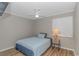 Cozy bedroom with a full-sized bed, ceiling fan, and simple decor at 191 Maison Dr. # B-323, Myrtle Beach, SC 29572