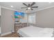 Bright bedroom with a ceiling fan, a TV, a dresser, and a large window at 191 Maison Dr. # B-323, Myrtle Beach, SC 29572