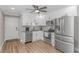 Fully equipped kitchen with stainless steel appliances, a black ceiling fan and modern countertops at 191 Maison Dr. # B-323, Myrtle Beach, SC 29572