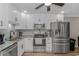 Modern kitchen with stainless steel appliances, granite counters, and white cabinets at 191 Maison Dr. # B-323, Myrtle Beach, SC 29572
