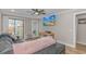 Bright living room featuring a comfortable sofa, wood-look flooring, and a sliding door to the balcony at 191 Maison Dr. # B-323, Myrtle Beach, SC 29572