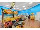 Brightly-lit game room with motorcycle racing game, claw machine, and tables at 201 N Ocean Blvd. # 2536, Myrtle Beach, SC 29572