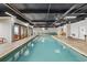 Indoor swimming pool area with lounge chairs, glass door access to the exterior, and ample lighting at 201 N Ocean Blvd. # 2536, Myrtle Beach, SC 29572