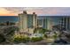 An aerial view showcases the oceanfront resort with its colorful pools and a modern architectural design at sunset at 205 74Th Ave. N # 1104, Myrtle Beach, SC 29572