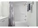 Shower-tub combination in bathroom with leaf-patterned shower curtain at 205 74Th Ave. N # 1104, Myrtle Beach, SC 29572