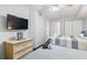 Bright bedroom featuring two beds, a flat-screen TV, and access to a bathroom at 205 74Th Ave. N # 1104, Myrtle Beach, SC 29572
