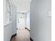 Bright hallway featuring wood floors, light blue walls, and a door, enhanced by a simple painting at 205 74Th Ave. N # 1104, Myrtle Beach, SC 29572