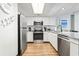 Bright kitchen with stainless appliances, granite counters, and sleek white cabinets offers a modern space at 205 74Th Ave. N # 1104, Myrtle Beach, SC 29572