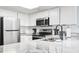 Kitchen featuring stainless appliances, granite counters, and white cabinets with plenty of counterspace at 205 74Th Ave. N # 1104, Myrtle Beach, SC 29572