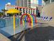 Outdoor pool area featuring a colorful splash fountain at 205 74Th Ave. N # 1104, Myrtle Beach, SC 29572
