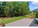 Lush backyard featuring a patio, green grass, mature trees, and well maintained landscaping at 2089 Suncrest Dr., Myrtle Beach, SC 29577