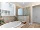 Bright bathroom featuring a soaking tub with tile surround, window, and glass enclosed shower at 2089 Suncrest Dr., Myrtle Beach, SC 29577