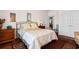 Bedroom featuring a queen bed, wood flooring, and a door leading to additional living space at 2089 Suncrest Dr., Myrtle Beach, SC 29577