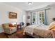 Bedroom featuring a queen bed, a chair, carpet flooring, and a large window with natural light at 2089 Suncrest Dr., Myrtle Beach, SC 29577