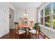 Cozy dining area features a wood table, four chairs, and a bright window with a view of the outdoors at 2089 Suncrest Dr., Myrtle Beach, SC 29577