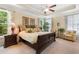 Spacious main bedroom with a trey ceiling, ceiling fan, carpet flooring and two sitting chairs at 2089 Suncrest Dr., Myrtle Beach, SC 29577