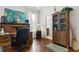 Bright home office featuring hardwood floors, built-in desk, cabinet, and view to a bathroom at 2089 Suncrest Dr., Myrtle Beach, SC 29577