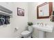 Stylish powder room with a pedestal sink, framed mirror, decorative accents and tasteful decor at 2089 Suncrest Dr., Myrtle Beach, SC 29577