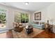 Sitting room featuring a comfortable armchair, sofa, area rug, and large window overlooking the outdoors at 2089 Suncrest Dr., Myrtle Beach, SC 29577