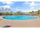 Large community swimming pool surrounded by palm trees and a spacious deck with lounge chairs at 2089 Suncrest Dr., Myrtle Beach, SC 29577