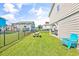 A quaint backyard featuring a manicured lawn, picnic table, and a black fence at 209 25Th Ave. N, North Myrtle Beach, SC 29582