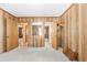 A vintage bedroom featuring wood paneled walls, neutral carpet, and multiple doorways at 209 25Th Ave. N, North Myrtle Beach, SC 29582
