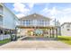 Charming raised beach house with large carport and partially covered outdoor space for entertaining at 209 25Th Ave. N, North Myrtle Beach, SC 29582