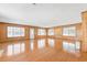 A spacious living room features hardwood floors, wood paneling, and an abundance of natural light at 209 25Th Ave. N, North Myrtle Beach, SC 29582