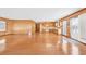 Open living space leading into the kitchen, featuring hardwood floors, paneled walls, and plenty of natural light at 209 25Th Ave. N, North Myrtle Beach, SC 29582