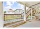Outdoor space beneath a deck with exposed columns, wood stairs, and lawn views at 209 25Th Ave. N, North Myrtle Beach, SC 29582