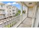 Balcony view overlooking the surrounding condos and palm trees under a blue sky at 209 Hillside Dr. N # 104, North Myrtle Beach, SC 29582