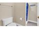 Clean bathroom with a white toilet, shower, and beach-themed decor at 209 Hillside Dr. N # 104, North Myrtle Beach, SC 29582