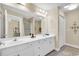 Spacious bathroom with double sink vanity, large mirror, tile floor, and a view to the bedroom at 209 Hillside Dr. N # 104, North Myrtle Beach, SC 29582