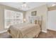 Cozy bedroom with a queen-size bed, natural light, and beach-themed decor at 209 Hillside Dr. N # 104, North Myrtle Beach, SC 29582