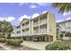 Inviting condo complex with private balconies and covered parking, surrounded by manicured landscaping at 209 Hillside Dr. N # 104, North Myrtle Beach, SC 29582